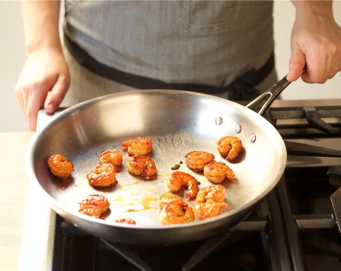 step 6 Meanwhile, in a large saute pan add the Granulated Sugar (2 Tbsp), one tablespoon of water, and lime juice to the pan. Cook for three to four minutes, shaking the pan throughout, until the sugar caramelizes and is the color of tea.