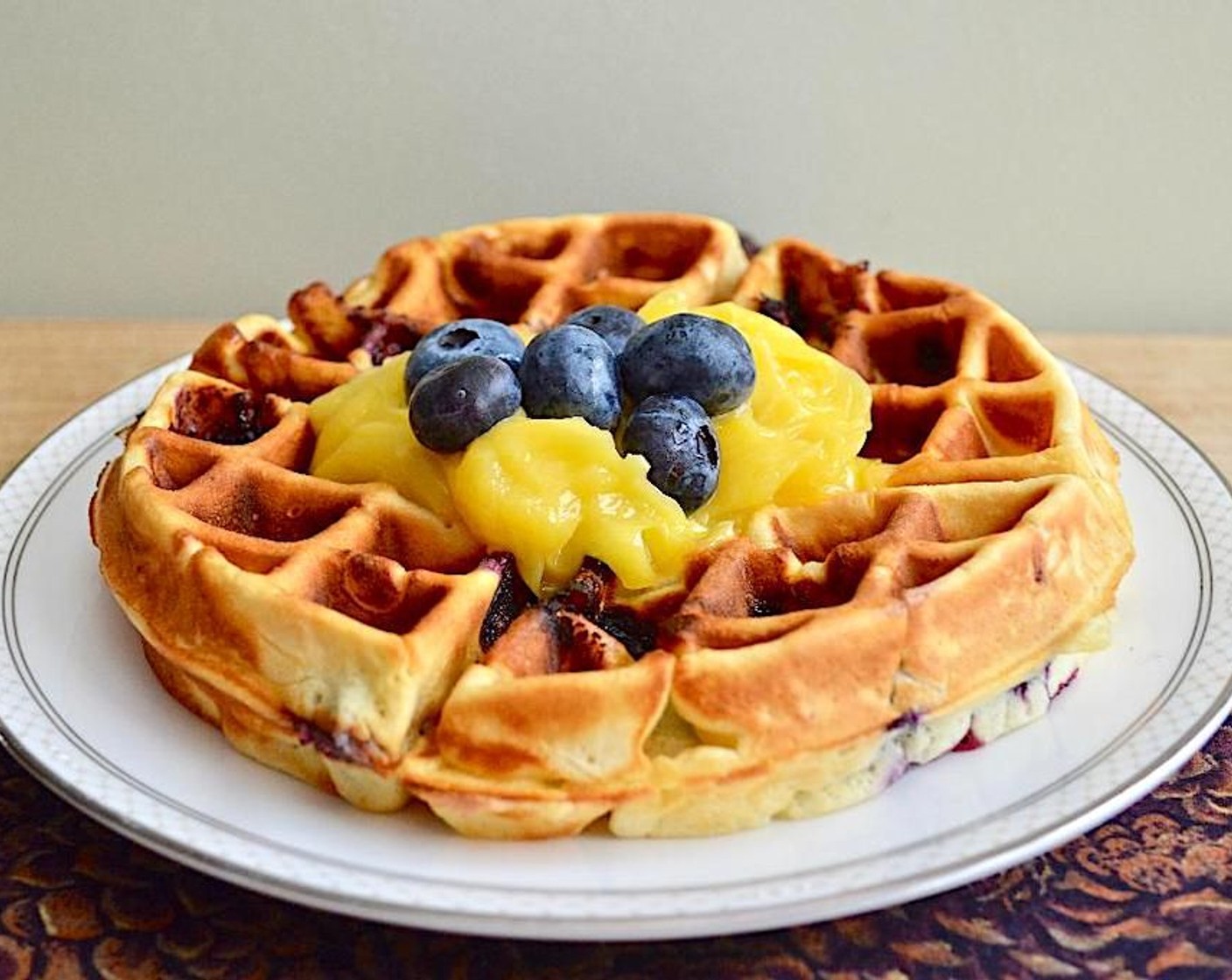 step 4 Serve it immediately with 1/4 cup of the Lemon Curd (1 cup) on top and extra blueberries. Repeat this with the remaining batter to get 4 big waffles total. Enjoy!