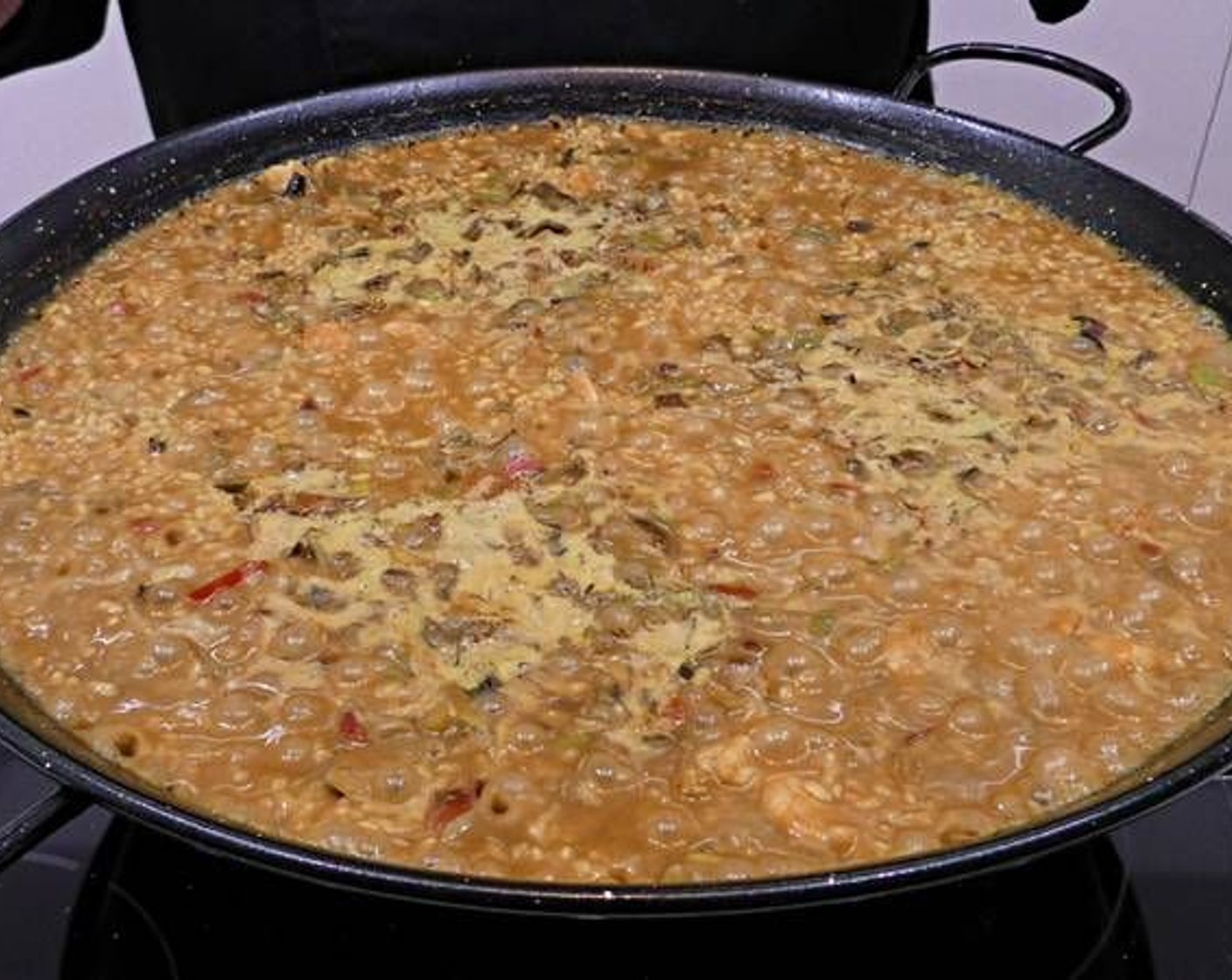 step 8 After 12 minutes have elapsed lower the heat to medium and cook for another 8 minutes. Afterward, turn off the heat cover the pan with the lid or a cloth, being careful so that it does not touch the rice.