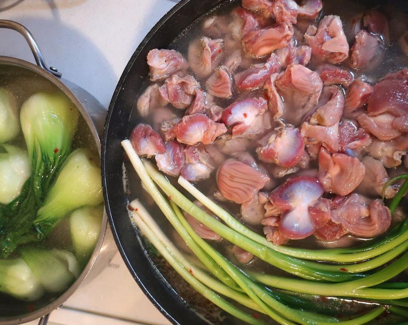 step 3 To make the broth, add Chicken Stock (8 cups), Garlic Paste (1 tsp), Fresh Ginger (1/2 tsp) Granulated Sugar (1/2 Tbsp) and Scallion (1 bunch) seasoned lightly with Kosher Salt (to taste) and Crushed Red Pepper Flakes (to taste), simmer Chicken Gizzards (2 lb) until tender but still with a slight bite,  2 hours.