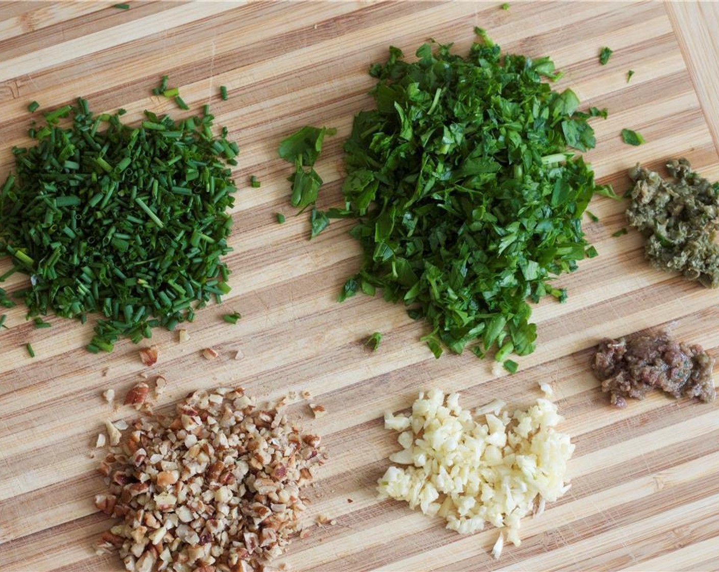 step 2 Set the Hanger Steak (1 lb) out and let come to room temperature. Chop the Roasted Pecans (1/4 cup) and Capers (1/2 Tbsp). Mince the Garlic (3 cloves). Finely chop the Fresh Chives (1/4 cup) and Fresh Parsley (1 cup). Mince the Anchovies (2).