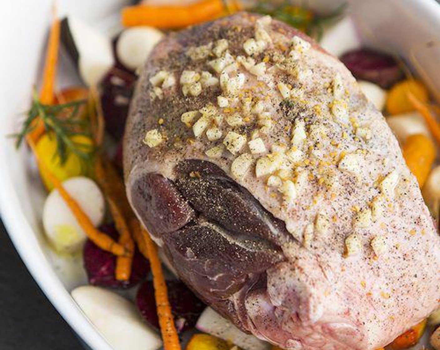 step 4 Arrange the seasoned leg of lamb on top of the vegetables.