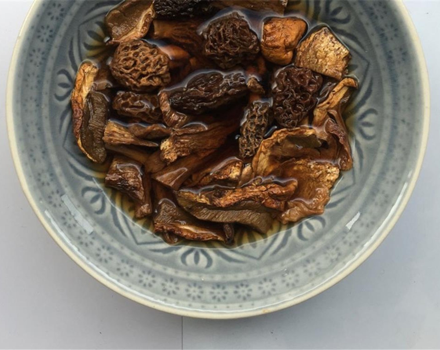 step 1 Transfer the Dried Morel Mushrooms (6) and Dried Porcini Mushrooms (3 Tbsp) to a medium bowl and add half a cup of Water (1/2 cup). Let the mushrooms soak in the water for 30 minutes.