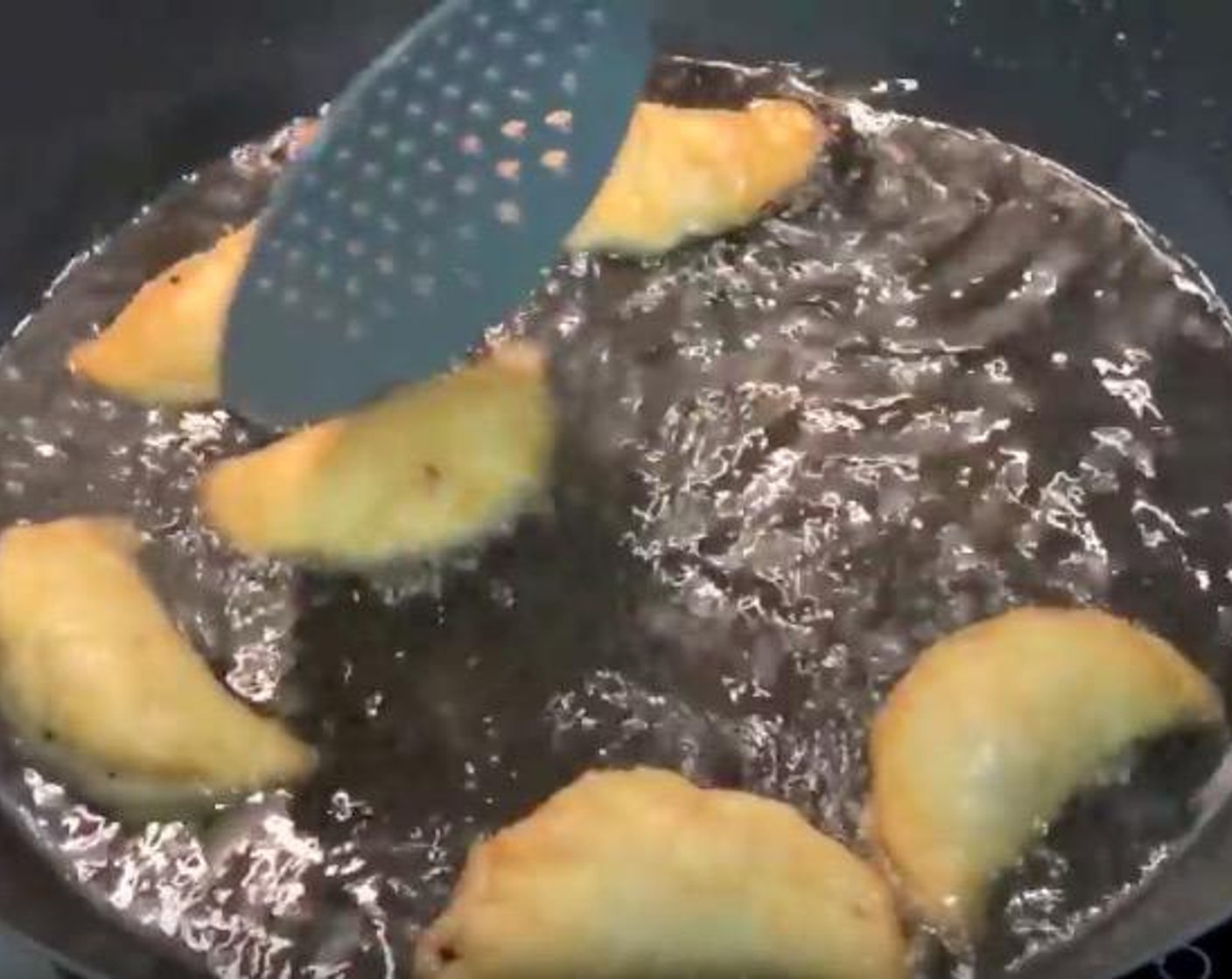 step 3 Put some vegetable oil in a wok, heat up the oil to 170 degree C (340 degrees F). Put the curry puffs into the oil and let it fried for 3 to 4 minutes. Transfer them to a tray lined up with some kitchen paper to get rid of the excess oil.