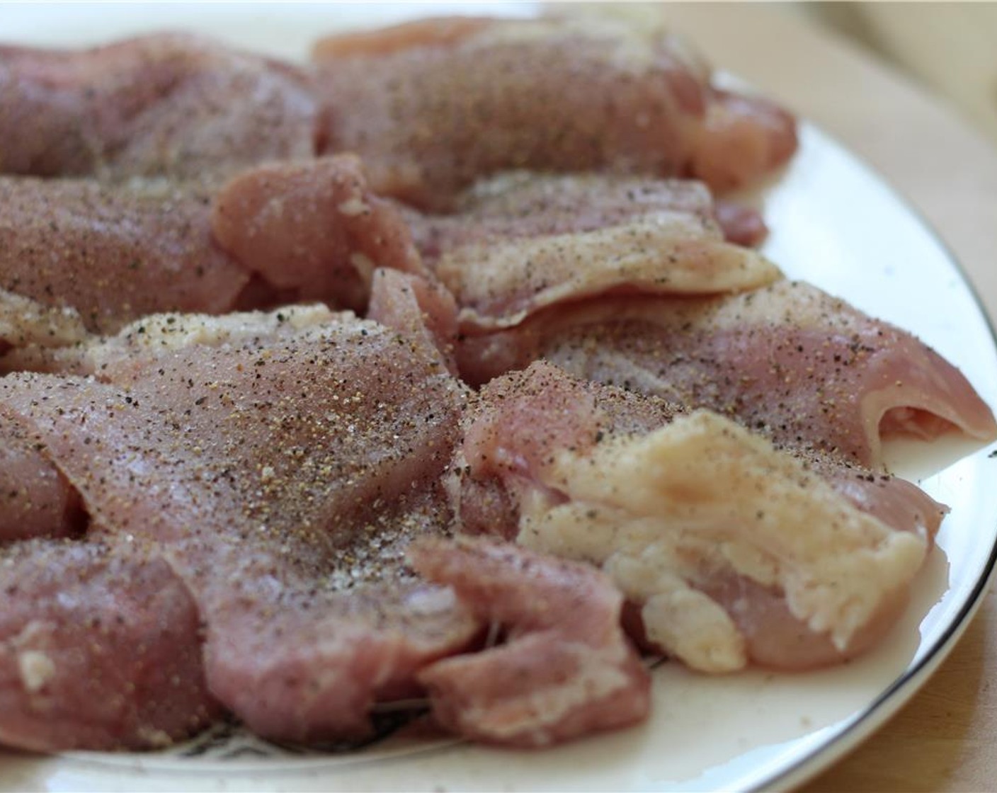 step 7 Season Chicken Thighs (455 g) on one side with Salt (to taste) and Ground Black Pepper (to taste).