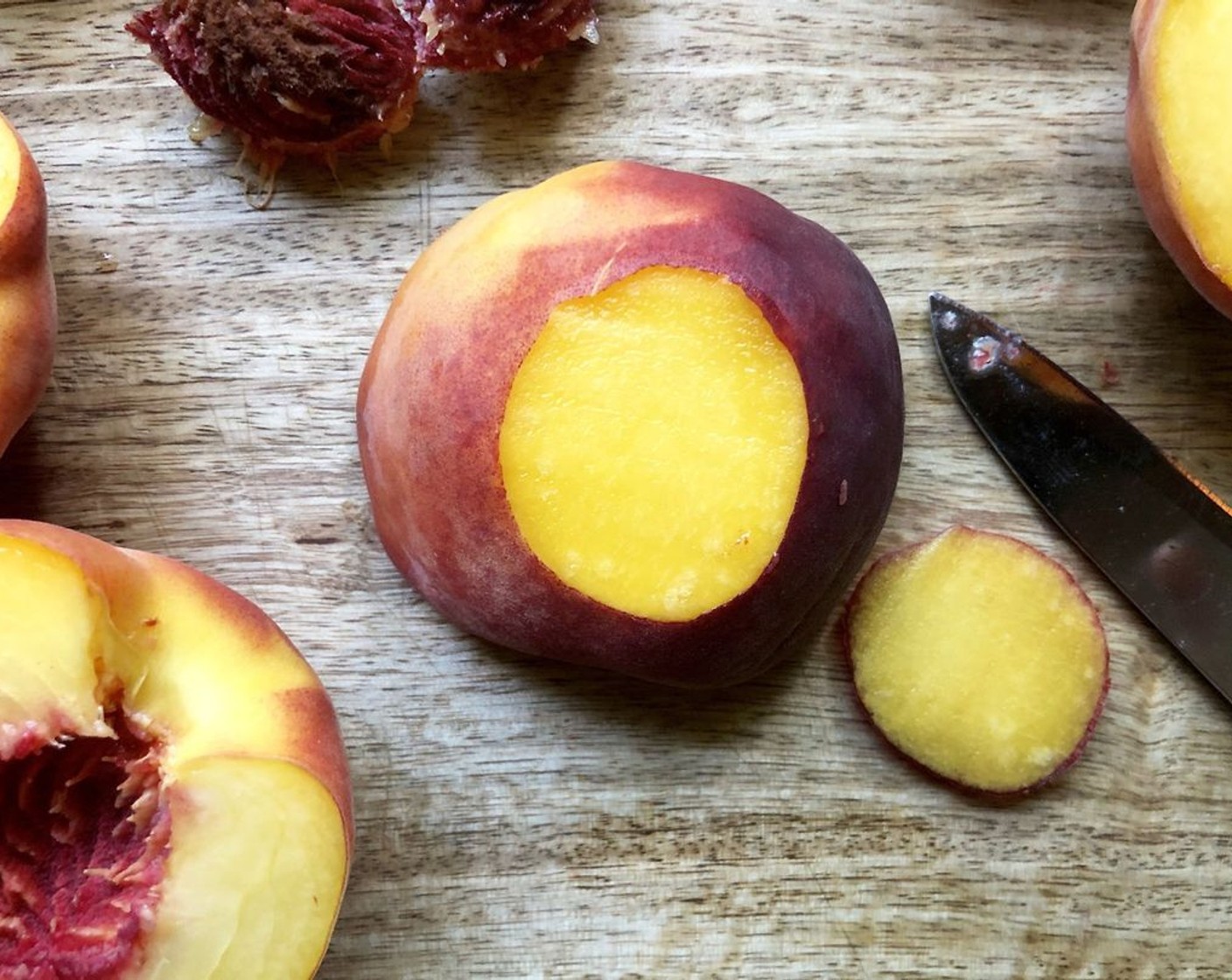 step 2 Trim a very thin slice from the round side of each Peaches (6) half so halves stand flat on the baking pan. Dip peach halves in Butter (1/4 cup) to coat. Arrange peach halves, cut sides up, in prepared pan.