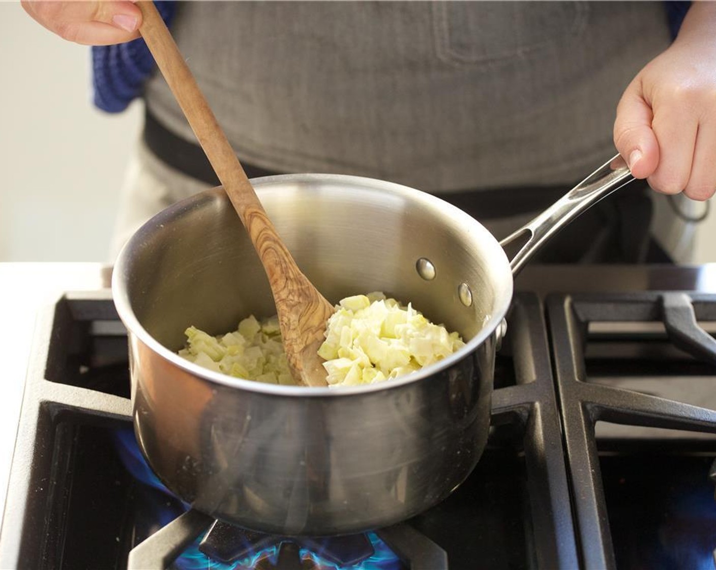 step 2 In a medium saucepan over low heat, add Unsalted Butter (2 Tbsp) and Olive Oil (1 Tbsp). Add the leeks and cook for five minutes until translucent.