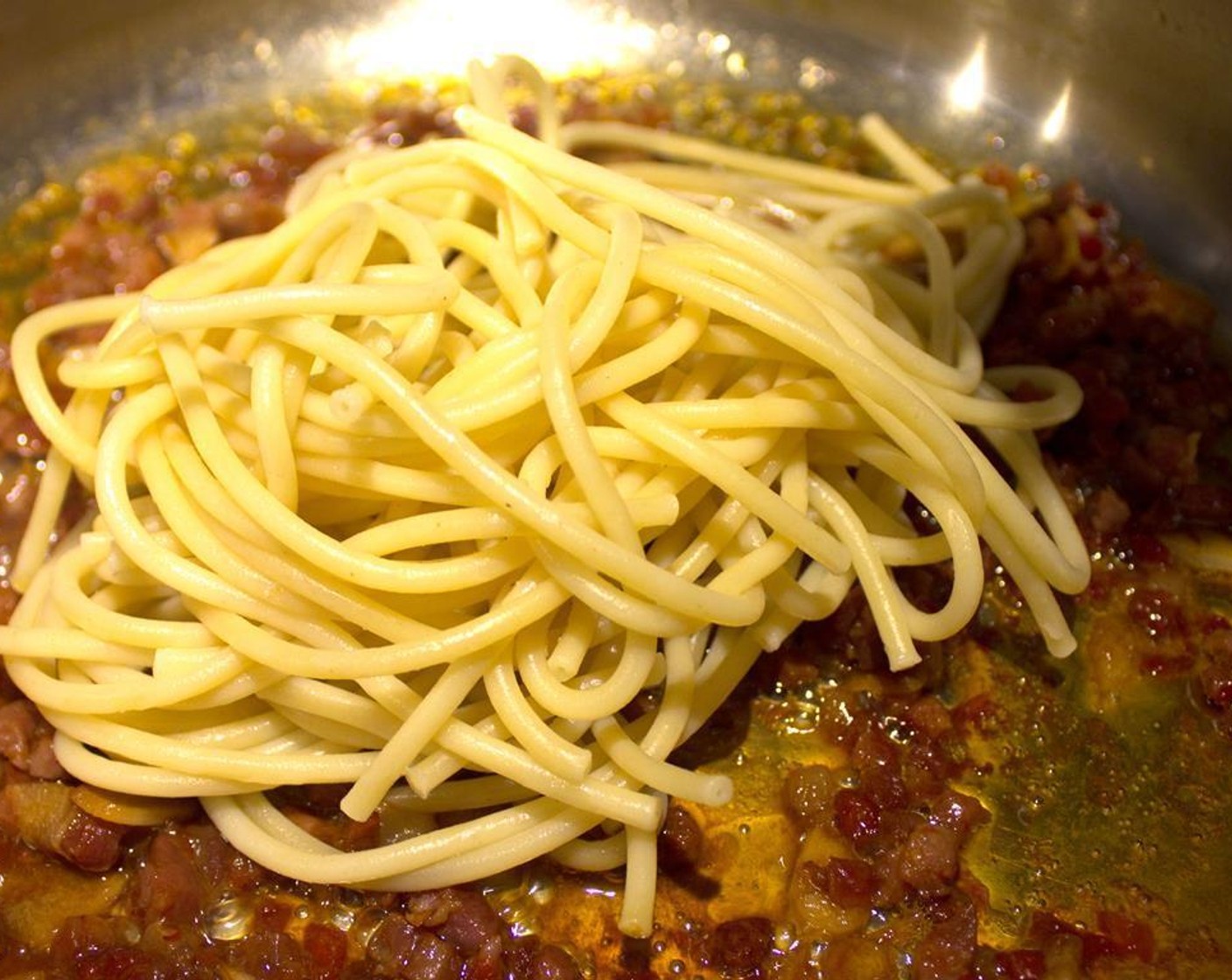 step 5 Once cooked to al dente, drain the pasta, reserving the water, and add pasta to the skillet.