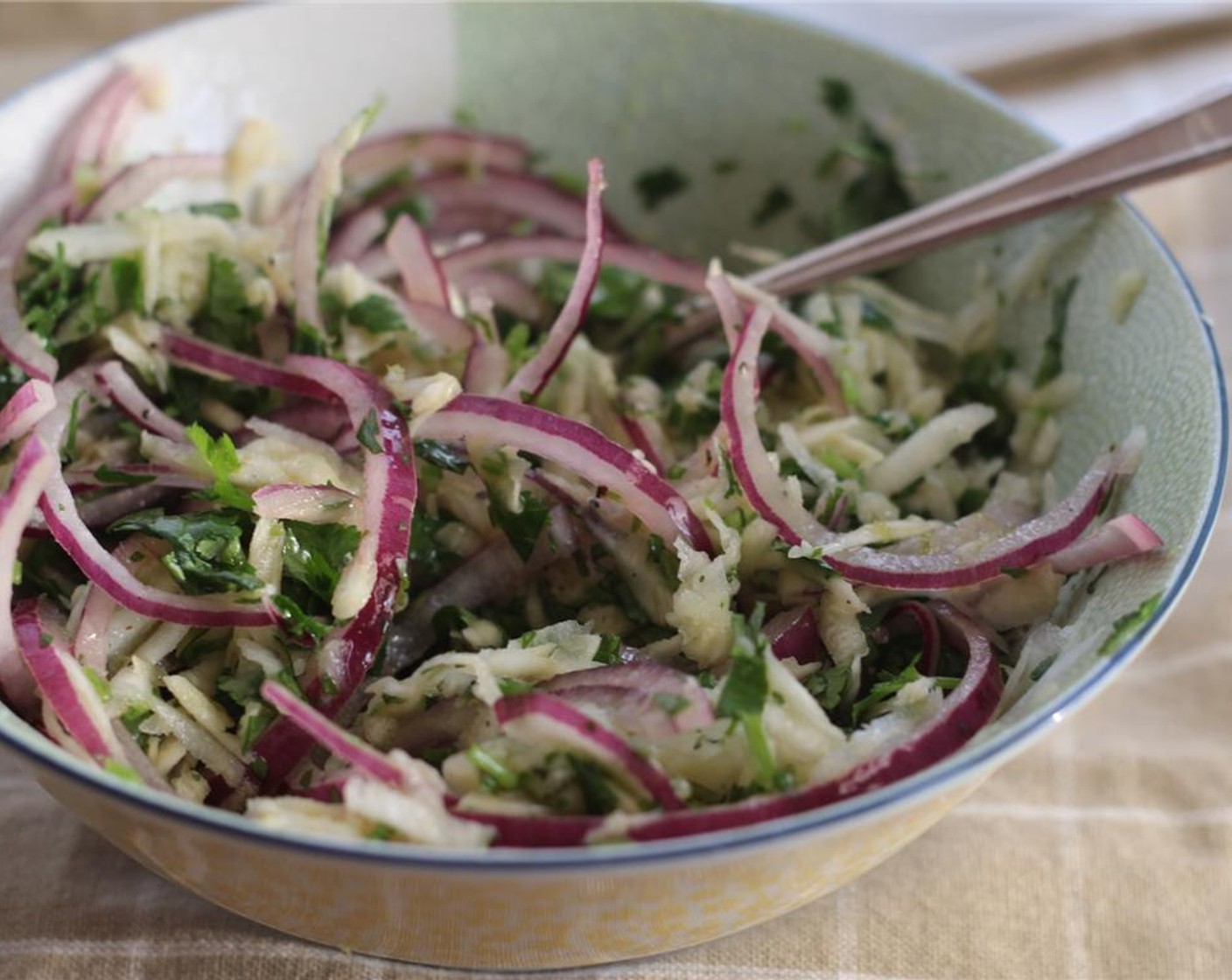 step 9 Combine the grated kohlrabi, sliced red onion, and cilantro with the key lime juice dressing. Season to taste.