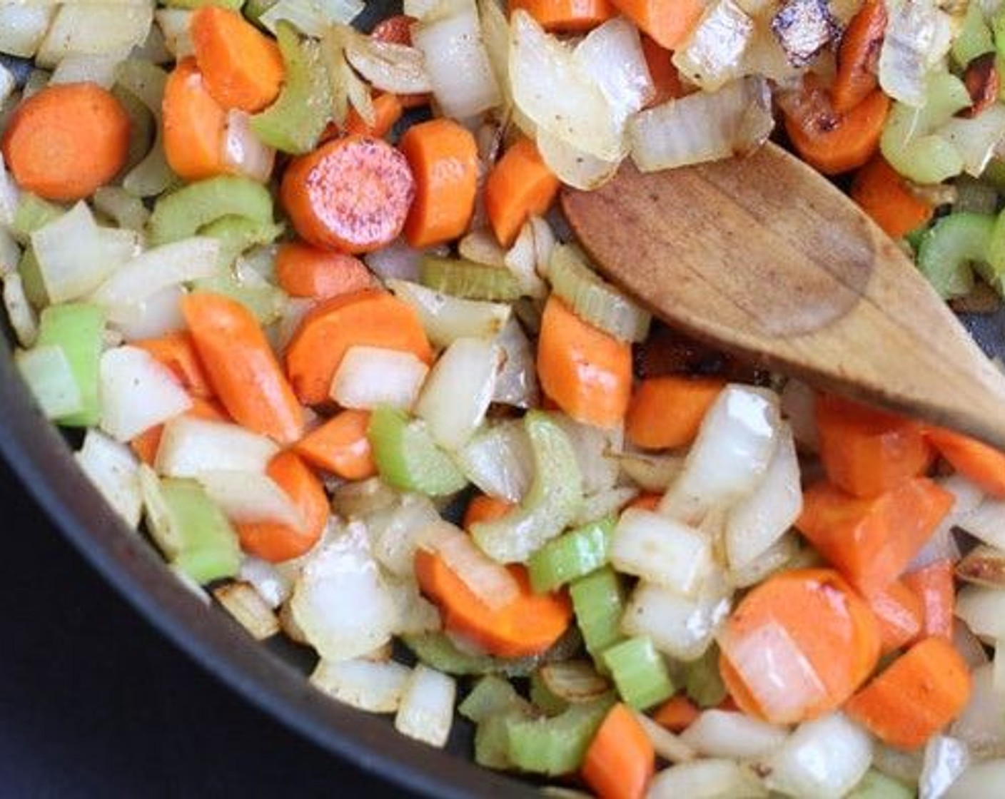 step 5 Increase heat to medium-high and add Yellow Onion (1), Carrots (2), and Celery (2 stalks) sauteéing and stirring occasionally until lightly caramelized.