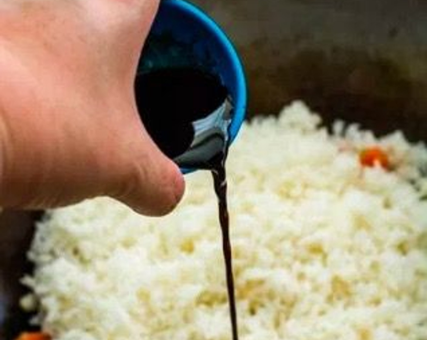 step 5 Add the cooked White Rice (2 cups) to the wok, then drizzle Soy Sauce (2 Tbsp) over the top. Stir-fry until the rice is evenly coated in the soy sauce.