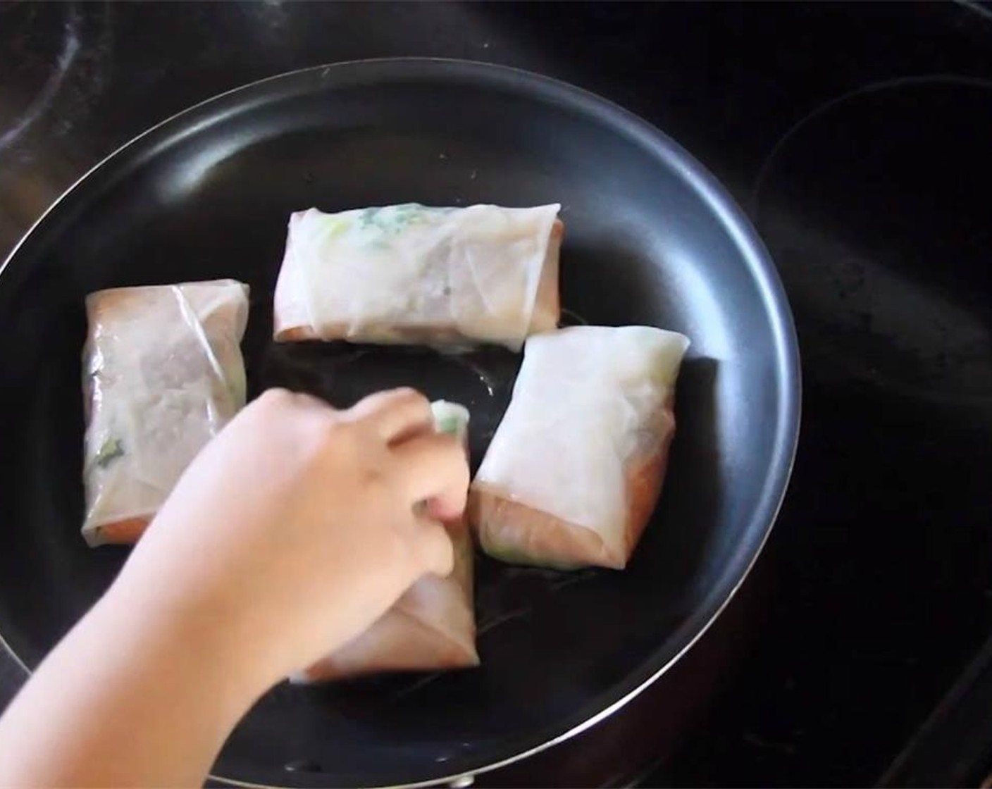 step 17 Once the oil is hot, add the bundles to the pan, sealed side down, and brown for about 1-2 minutes.