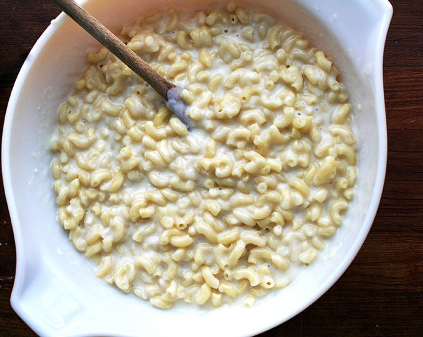 step 7 In a large bowl, toss macaroni with Parmigiano-Reggiano (1 1/2 cups) — it's ok if the noodles are sticking together; they will separate once the béchamel is poured over top. Pour the béchamel over top and stir to mix.