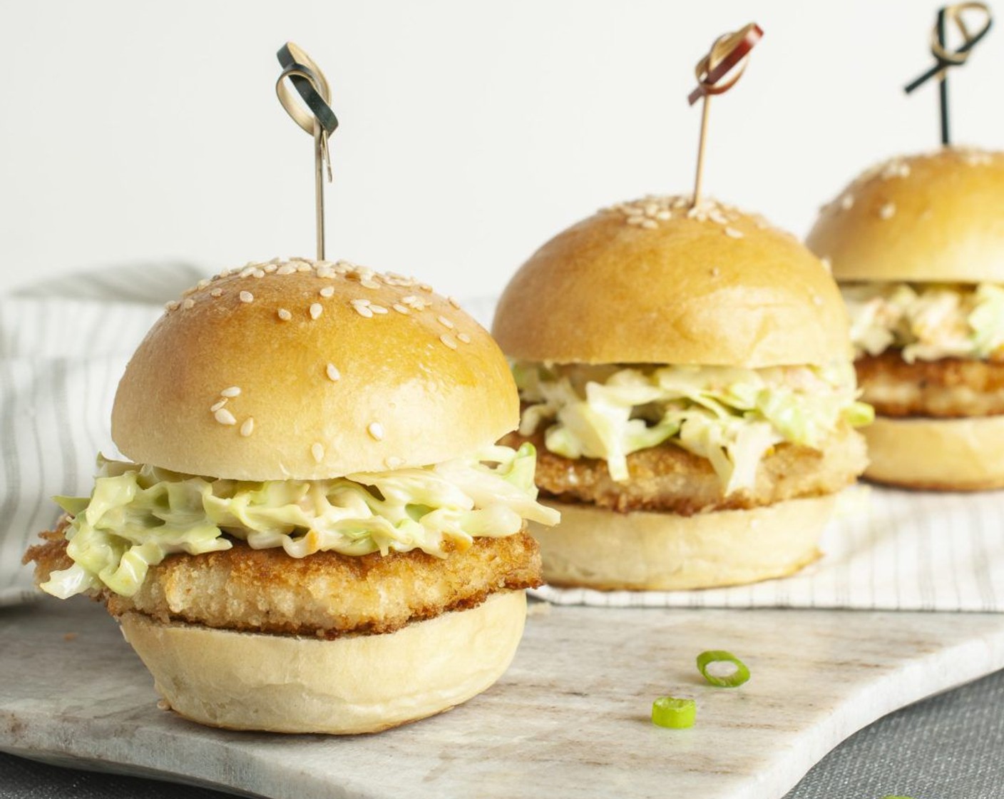 step 9 To each slider bun, add a chicken cutlet and top with a generous amount of wasabi slaw. Secure each slider with a long toothpick if desired and serve immediately.