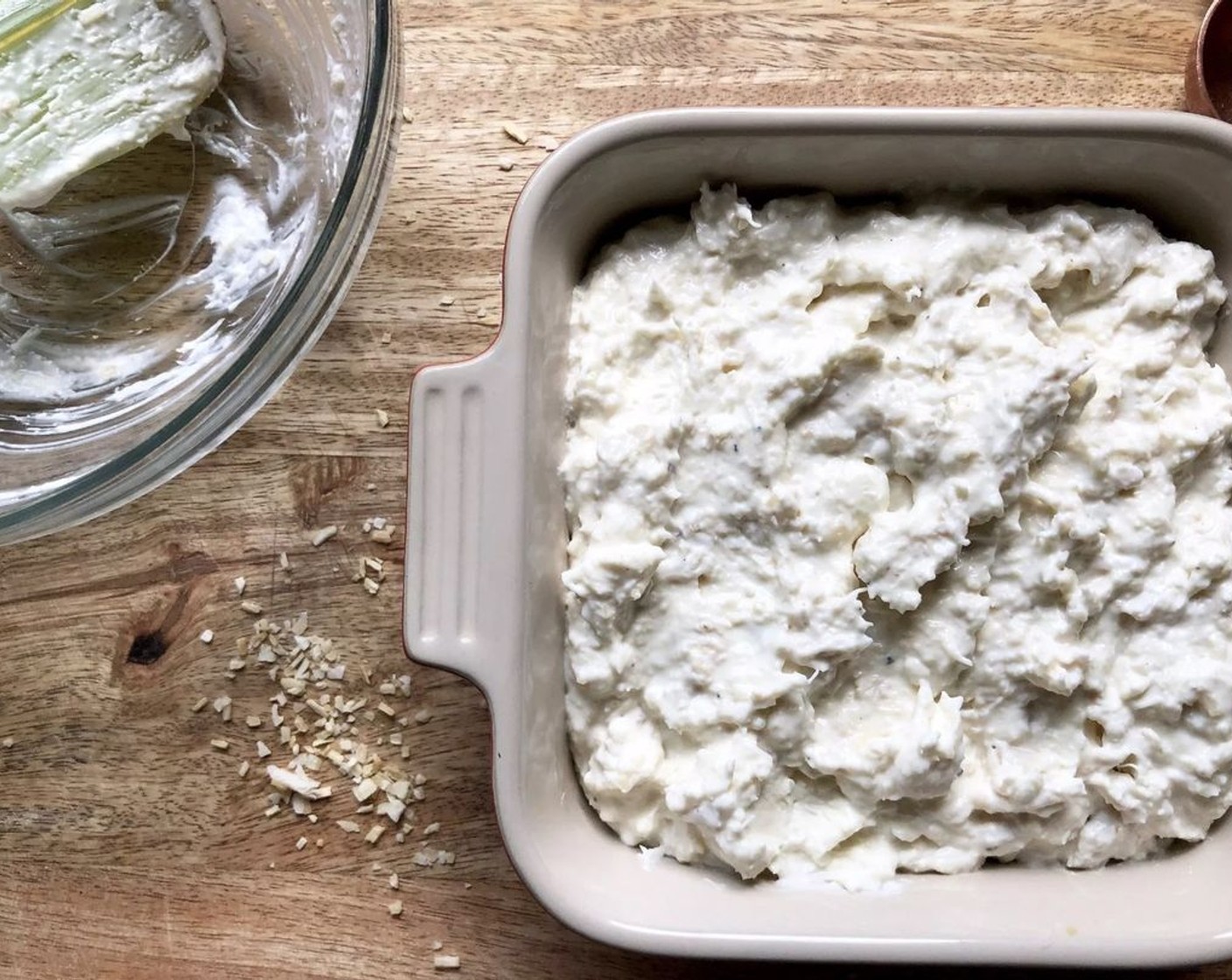 step 2 Combine Cream Cheese (1 cup), Fresh Crab Meat (6.5 oz), Milk (1 Tbsp), Onion Flakes (1 Tbsp), Horseradish (1 Tbsp), Salt (1/4 tsp), and Freshly Ground Black Pepper (1/4 tsp) in a medium-size bowl. Mix until well incorporated. Transfer to a small baking dish.