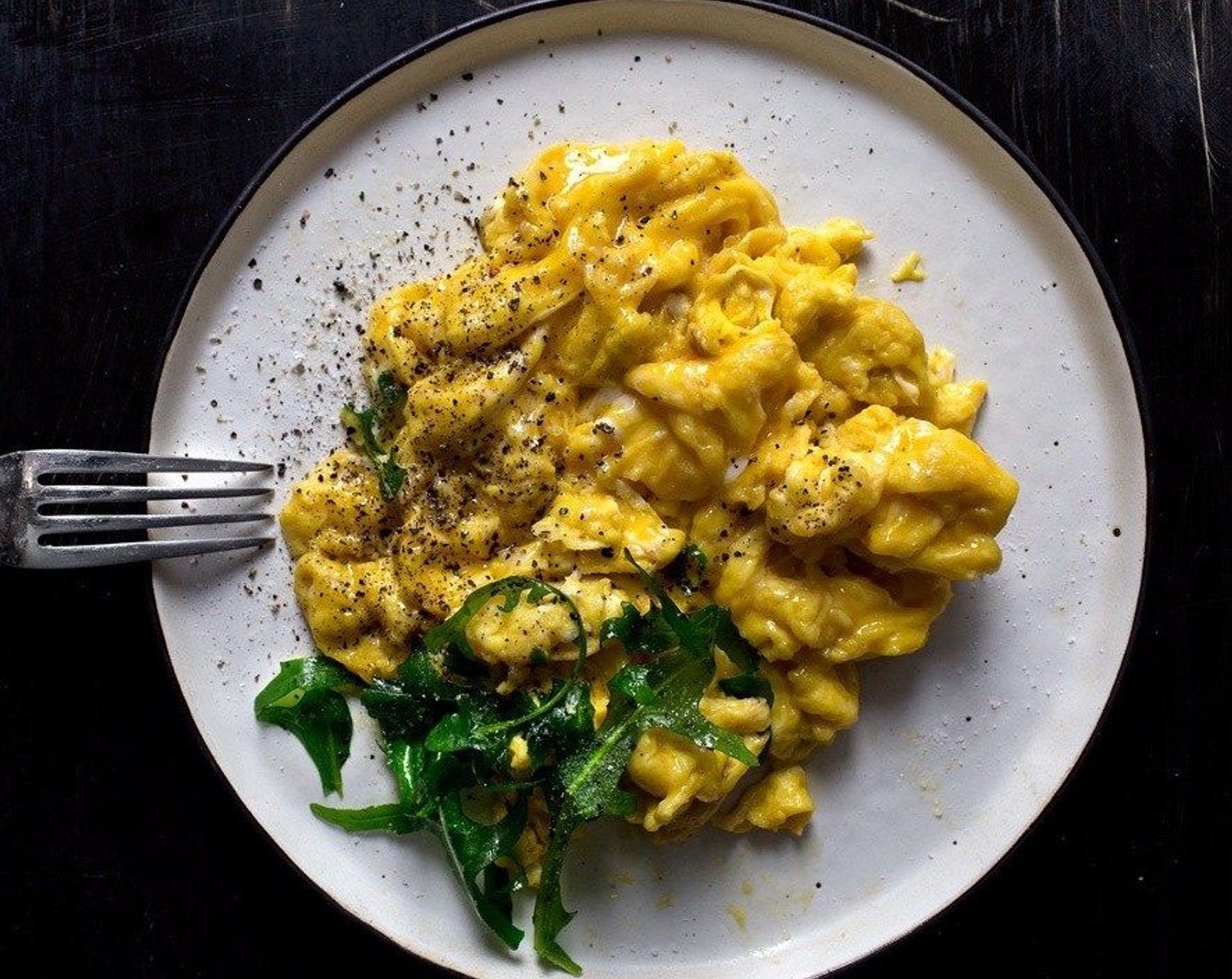 Premium Photo  Scrambled, frying eggs from one egg in a small pan on  yellow background