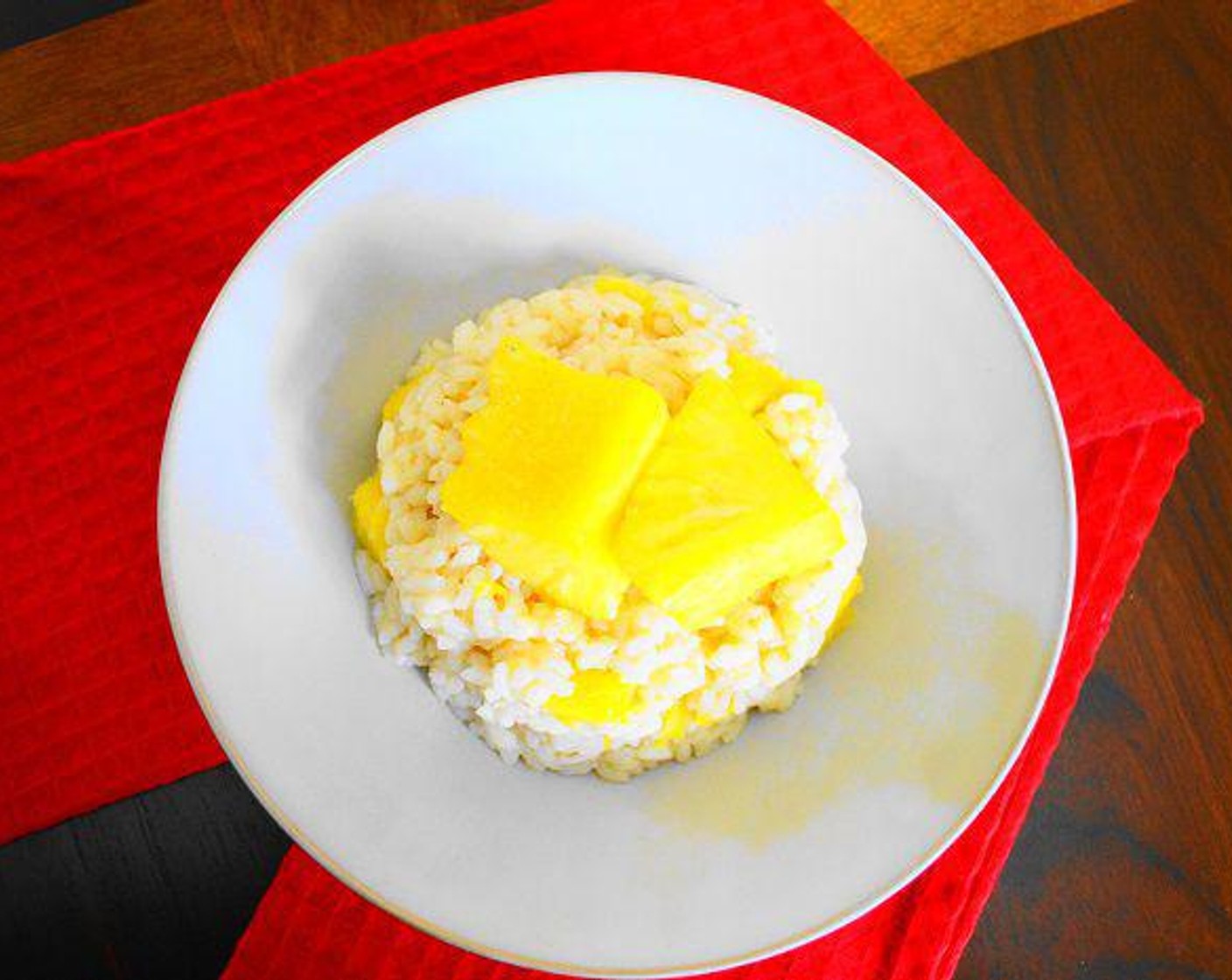step 5 When the rice is cooked, take it off of the heat and stir in the cooked pineapple chunks and Ricotta Cheese (1 Tbsp). Then just plate and serve the pineapple risotto! Garnish with additional Fresh Pineapple Chunks (to taste). Serve and enjoy!