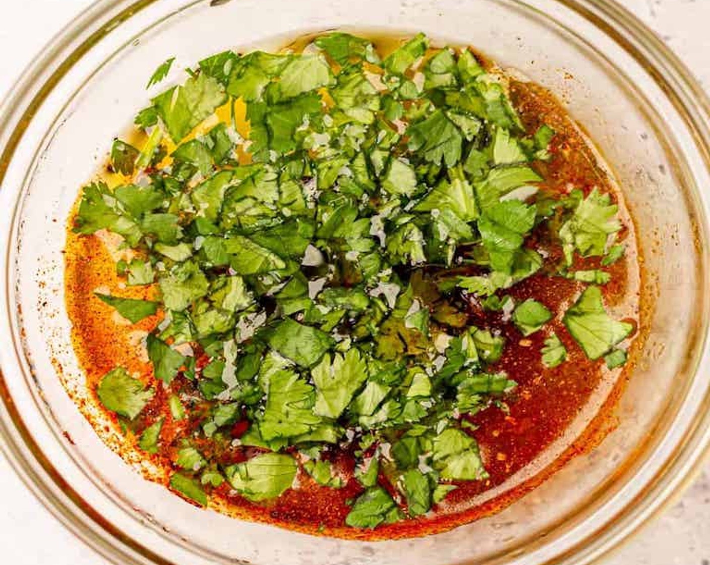 step 2 In a smaller bowl or jar, mix together Olive Oil (1/4 cup), Lime (1), Salt (1 tsp), Ground Black Pepper (1/2 tsp), Paprika (1/2 tsp), Cayenne Pepper (1/4 tsp), and Fresh Cilantro (2 Tbsp).