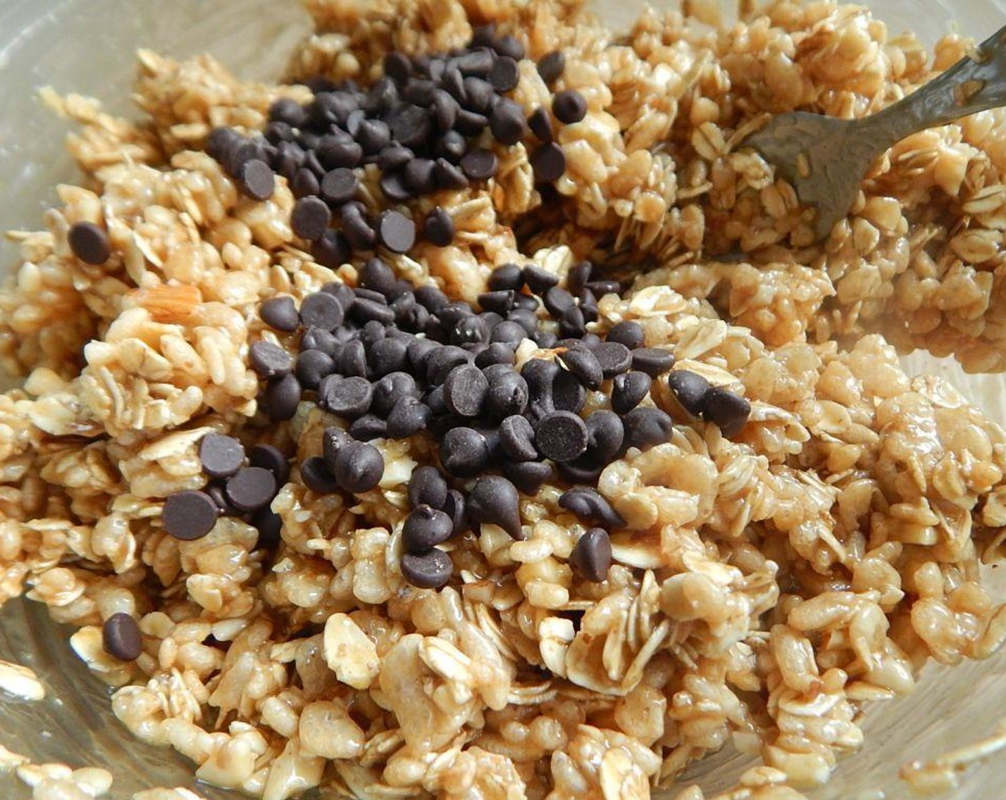 step 1 Spray a 9 inch pan and set aside. In a large bowl, mix your Rice Krispies® Cereal (1 3/4 cups), Oats (1 1/4 cups), and Almonds (1/4 cup). Save the Mini Chocolate Chips (2 Tbsp) for later.