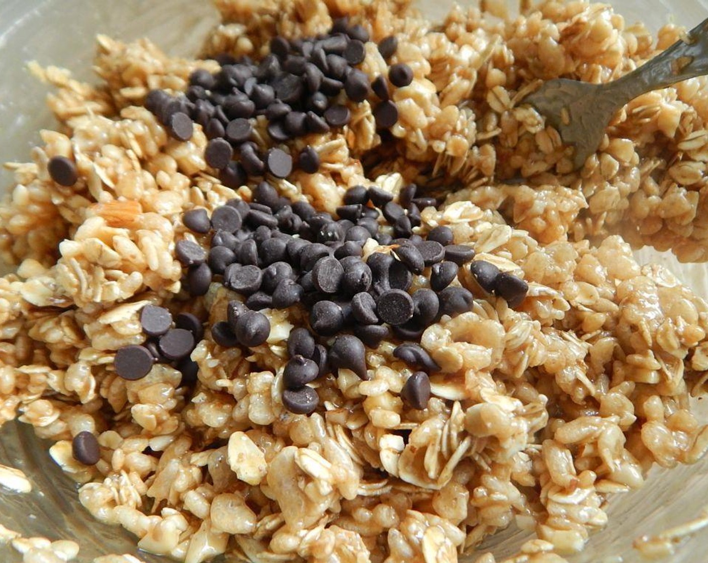 step 1 Spray a 9 inch pan and set aside. In a large bowl, mix your Rice Krispies® Cereal (1 3/4 cups), Oats (1 1/4 cups), and Almonds (4 Tbsp). Save the Mini Chocolate Chips (2 Tbsp) for later.