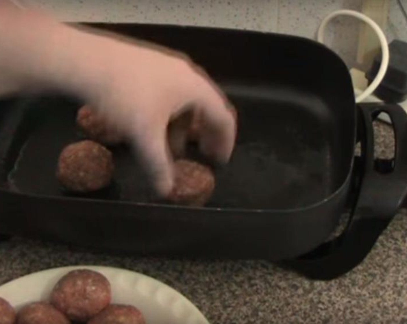step 3 Drop the meatballs into a heated fry pan, four at a time. Cook them for 5 to 6 minutes, turning them occasionally. After cooking, transfer the balls onto a baking dish.
