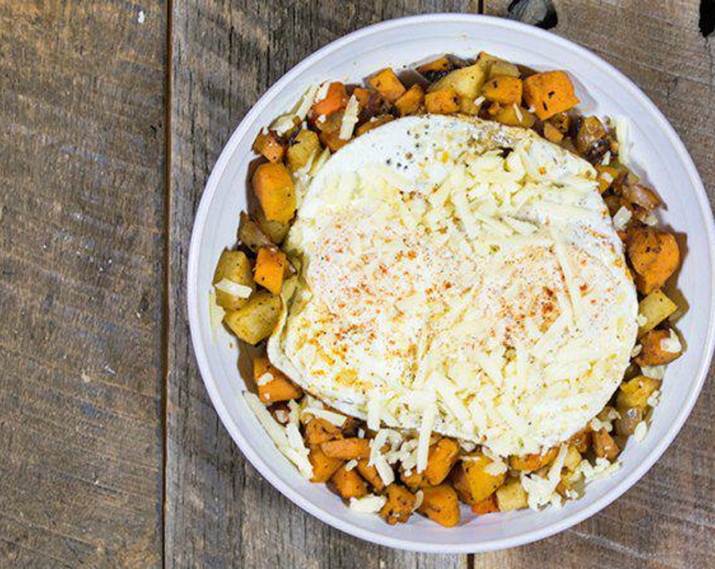 step 6 Top the root vegetables with eggs, sprinkle with any additional cheese, salt, pepper, and paprika, then serve!