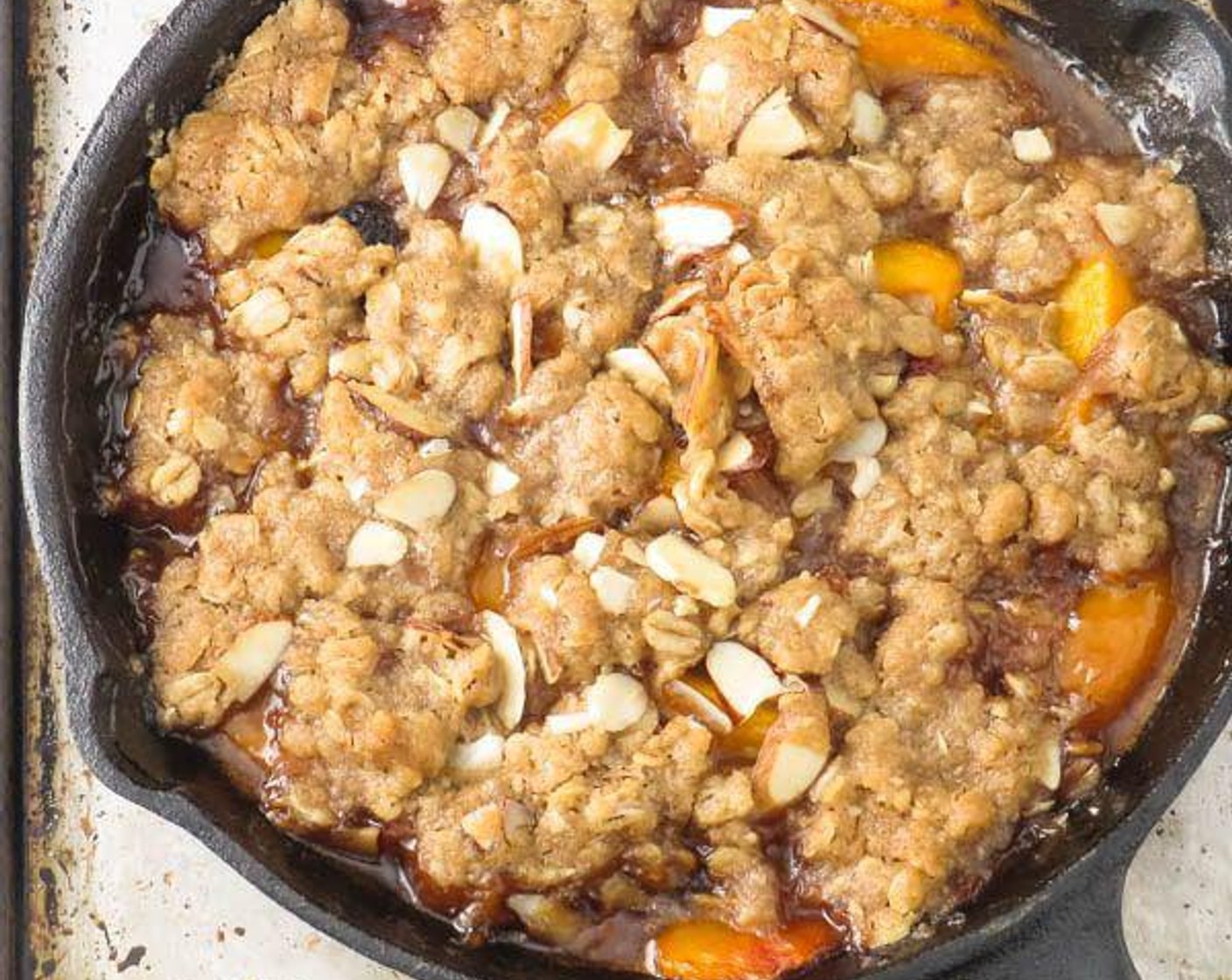 step 5 Remove pan from heat and divide crisp mixture in chunks on top of peaches. Bake 20-25 minutes, until golden brown.