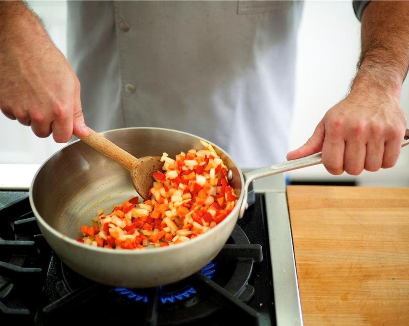 step 3 Heat a large saucepot over medium high heat. Add 1 tablespoon olive oil. Add the onion, peppers, and carrot. Cook for 5 minutes until onions are tender.