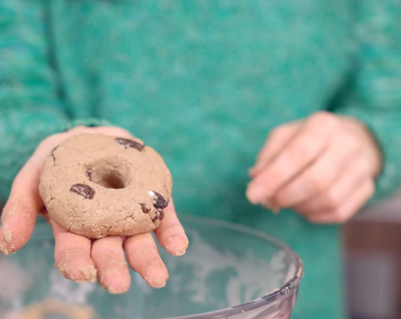step 6 Divide dough into 4 and form into a ball slightly larger than a golf ball. Form into a bagel by flattening the ball slightly and poking a hole through with your finger.