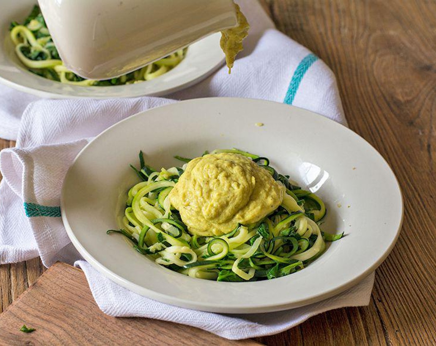 step 6 You can then add the cauliflower sauce into the same pan and stir to combine or you can serve the zucchini pasta up individually and top with your desired sauce on each plate!