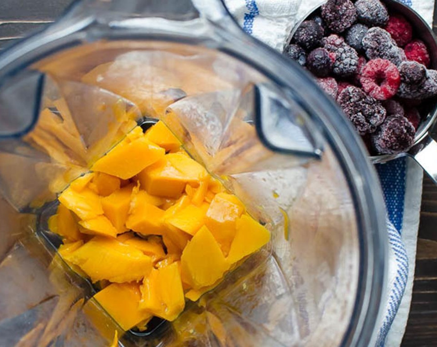 step 1 Add the Mango (1 cup) to the blender.