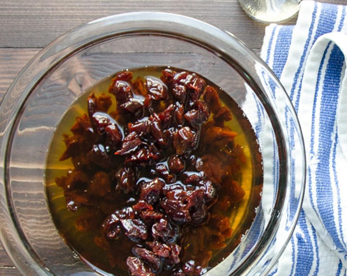 step 1 Roughly chop the Dried Cherry (1 cup) into quarters and transfer them to a small bowl. Add the Amaretto (3/4 cup) and let sit for one hour until plumped.