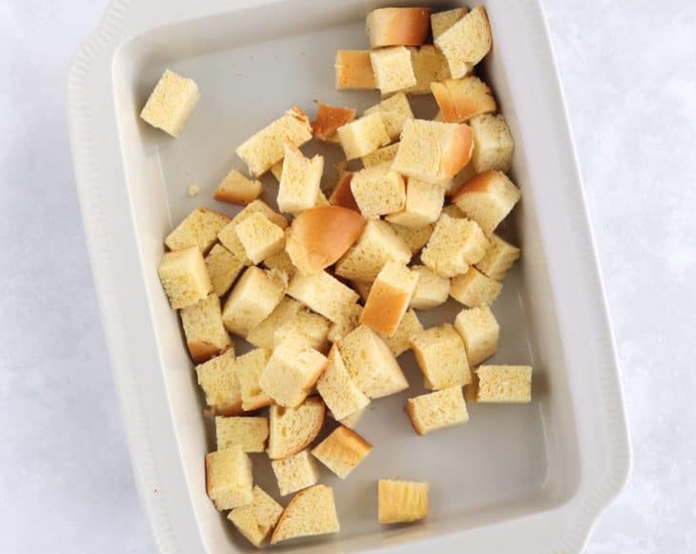 step 2 Layer half of the Brioche (1/2 loaf) cubes evenly in the prepared dish.