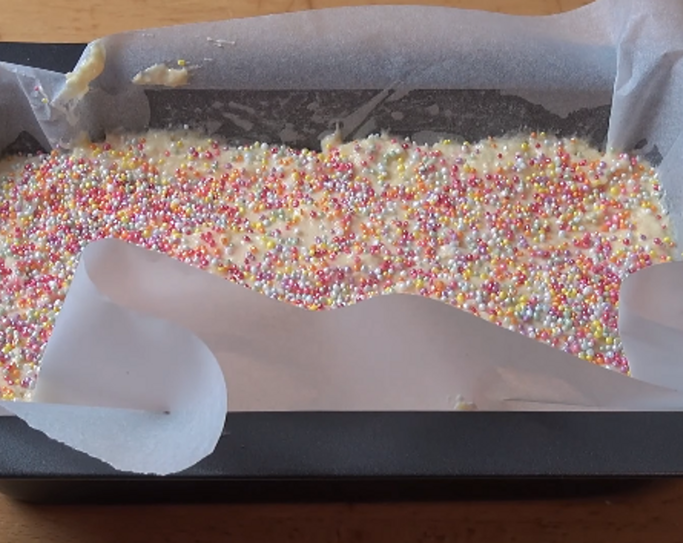 step 3 Grease a loaf pan and line with non-stick baking paper. Pour in cake mixture and level with a spoon. Finish with a layer of Sprinkles (4 Tbsp) on top. Cook at 180 degrees C (350 degrees F) for 45 minutes or until a skewer in the center comes out clean.