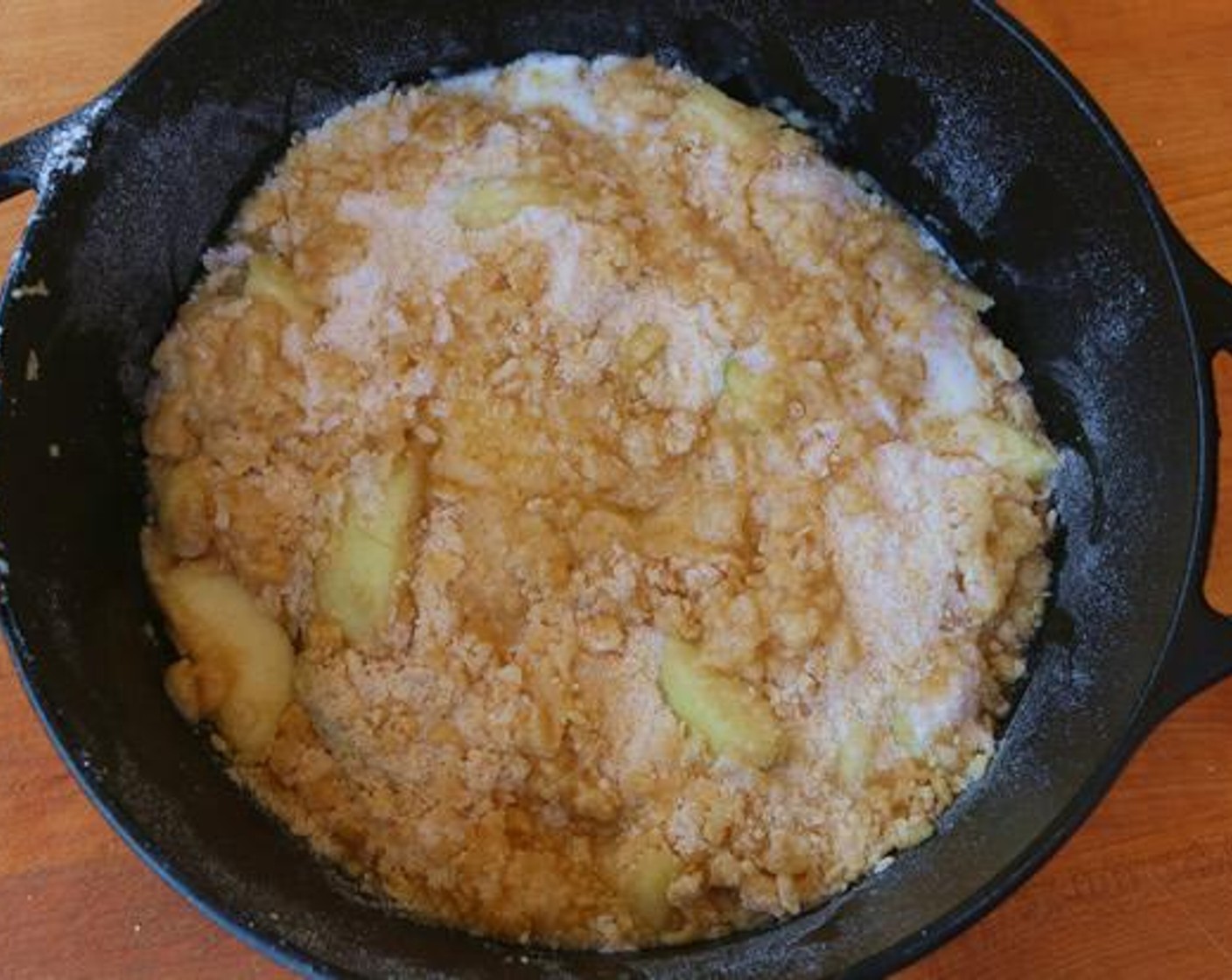 step 4 Place apples in a dutch oven, top with crumble batter mixture, and drizzle with Butter (1/2 cup).