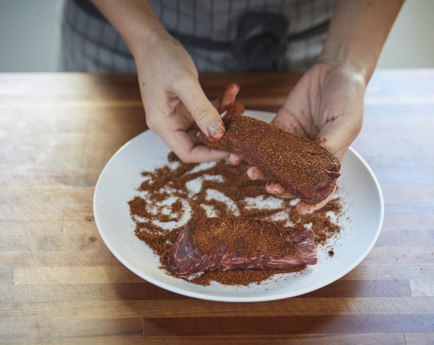 step 7 Pat dry the Hanger Steak (2 pieces) with paper towels. Season with Salt (1/4 tsp) and Ground Black Pepper (1/4 tsp). Roll the steaks in the ancho rub until well coated.