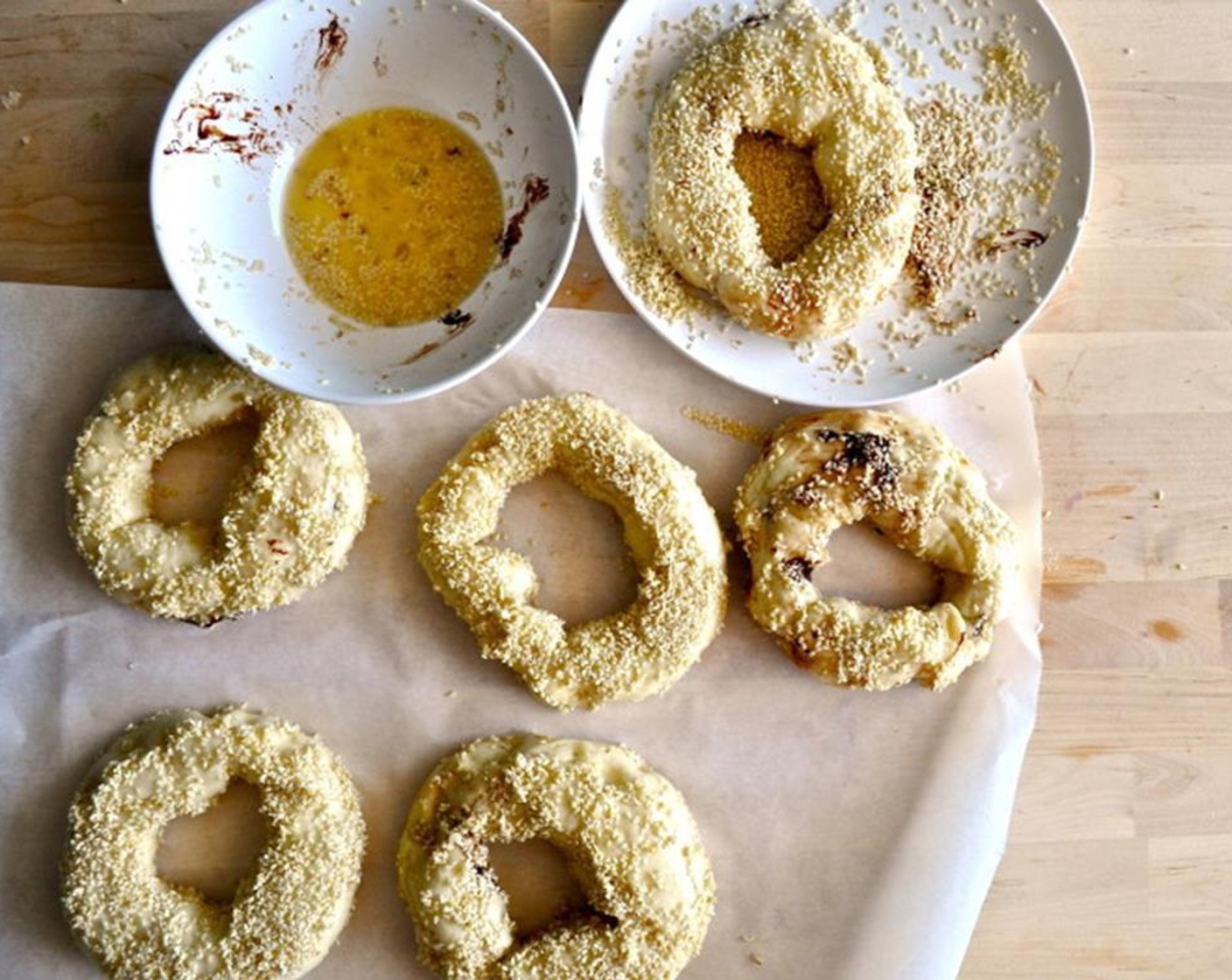 step 12 Dip your bagel in the egg wash and then coat both sides in the seeds. Note, the bagels tend to get very dark in areas where they are not covered with seeds.