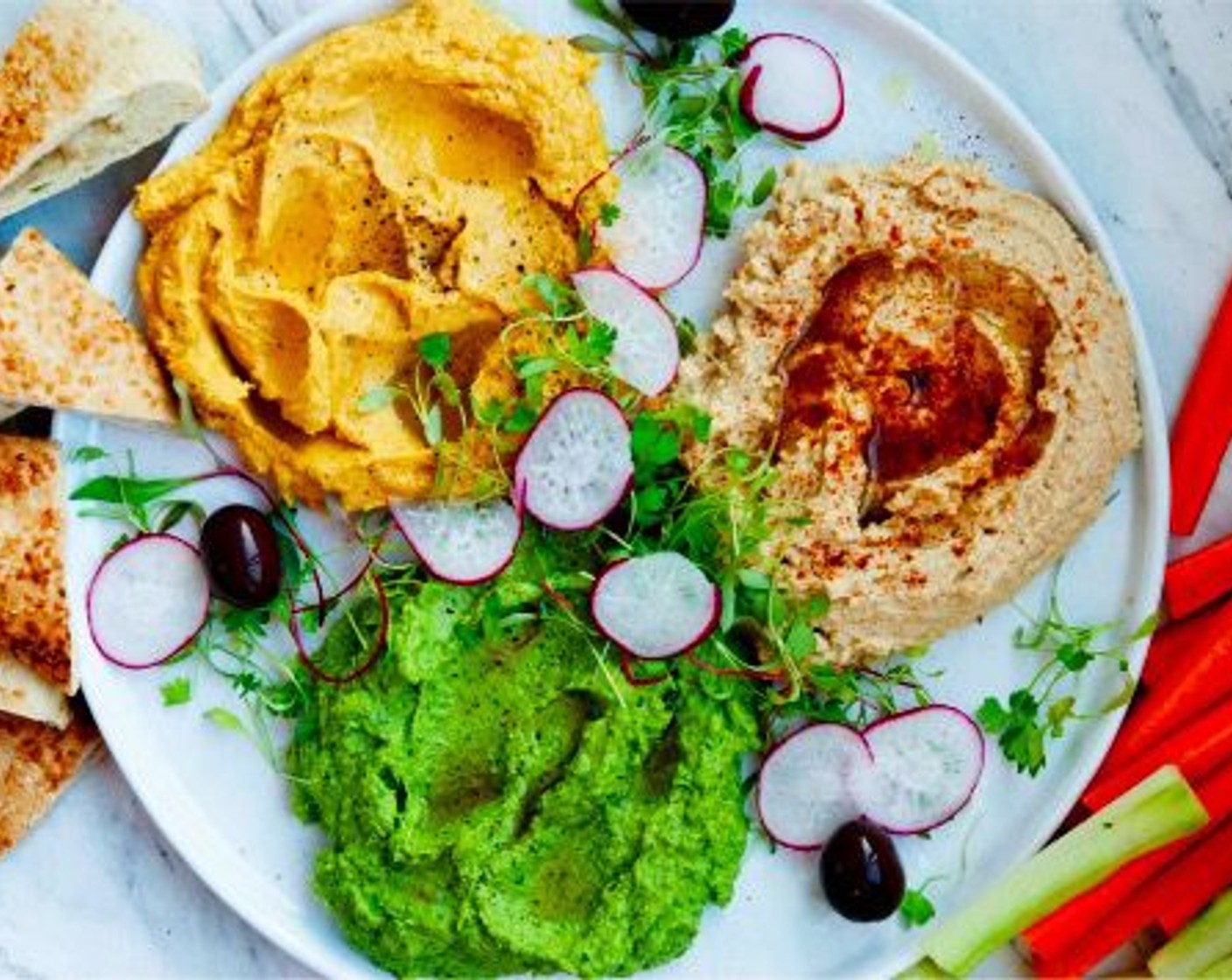 step 7 To serve, place the 3 hummus on a large plate. Drizzle all with additional extra virgin olive oil, then sprinkle some extra chili on the traditional one, and ground black pepper on the kale and pumpkin ones. Serve with veggie sticks and pita bread. Enjoy!