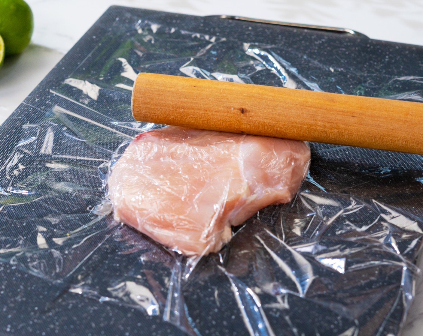step 2 Place the Boneless, Skinless Chicken Breasts (2) on the cutting board. Cover with cling wrap. Use a rolling pin to pound the chicken breast until it is evenly thick.