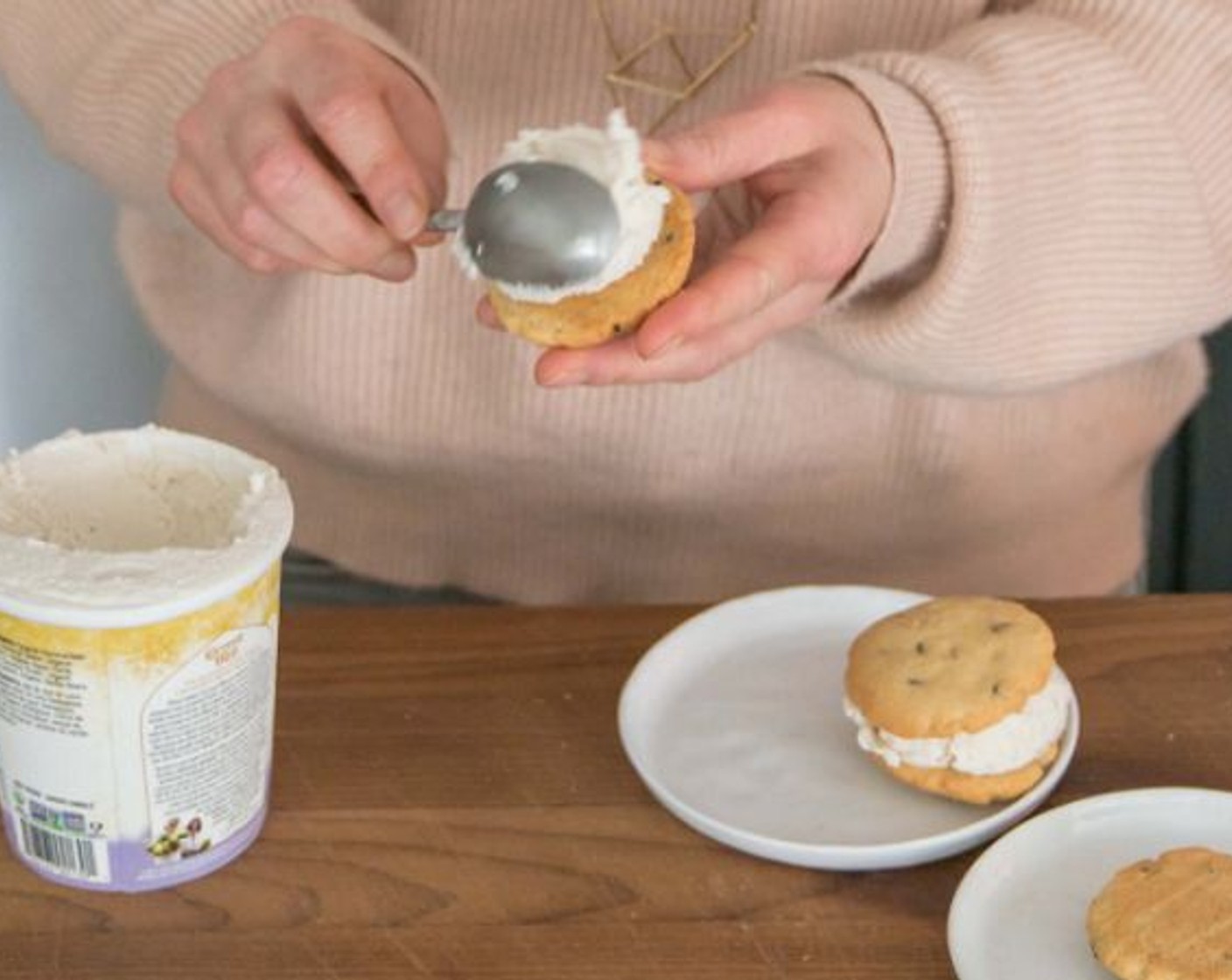 step 8 Using an ice cream scoop or a spoon, put about 3-4 tablespoons of Vanilla Ice Cream (2 cups) in between two cookies.