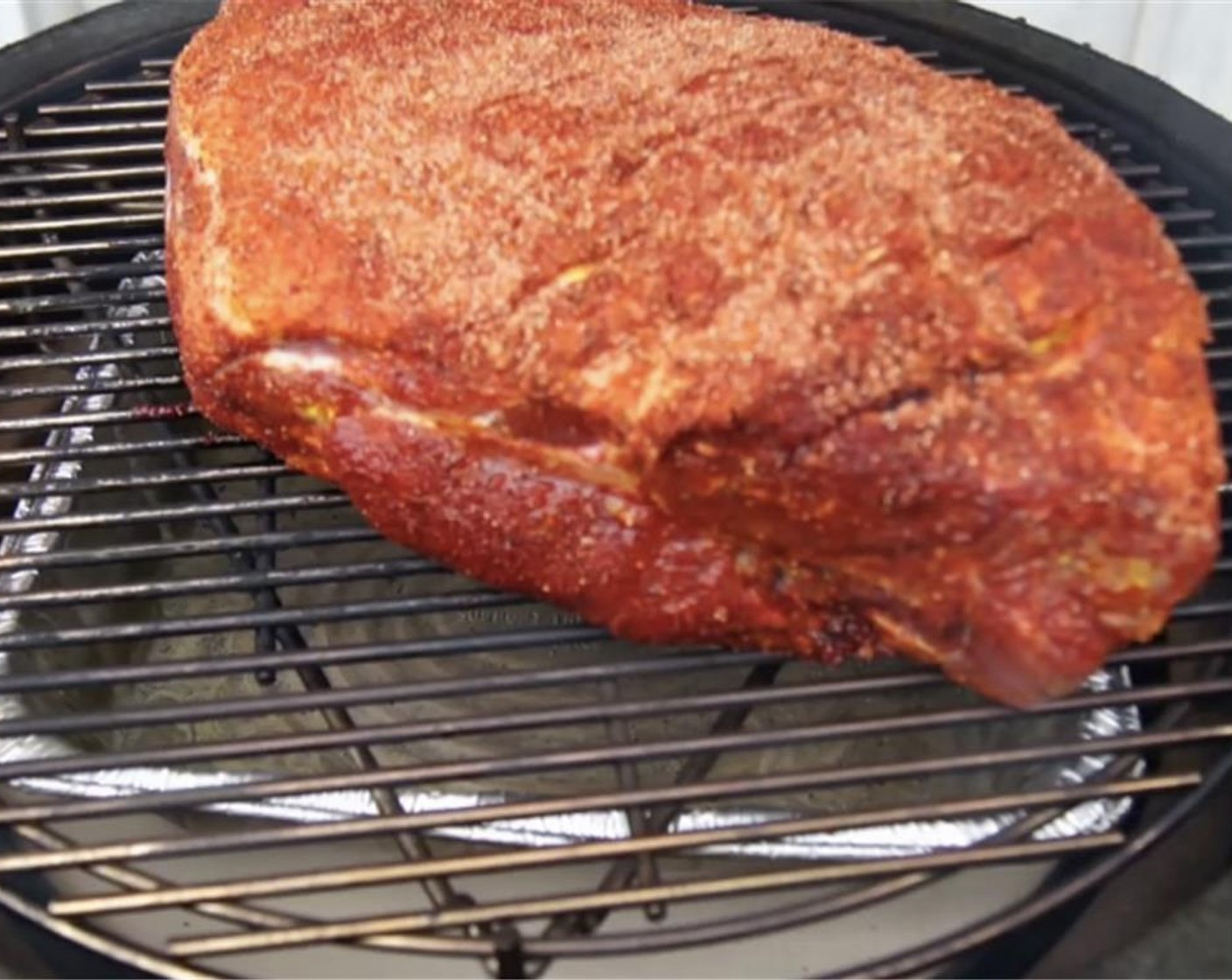 step 6 Set pork on the grill, fat side up. Cook for one hour then insert two meat thermometers into pork.