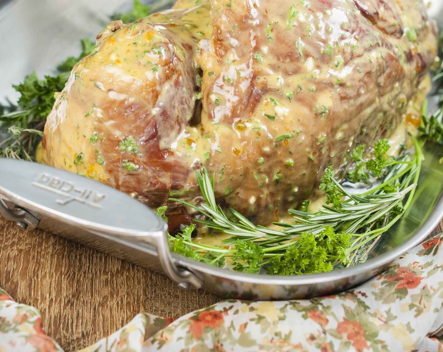 step 4 Lay ham face down in roasting pan and scatter Fresh Herbs (1 handful) around the ham. Smear half of the mustard rub evenly over ham.