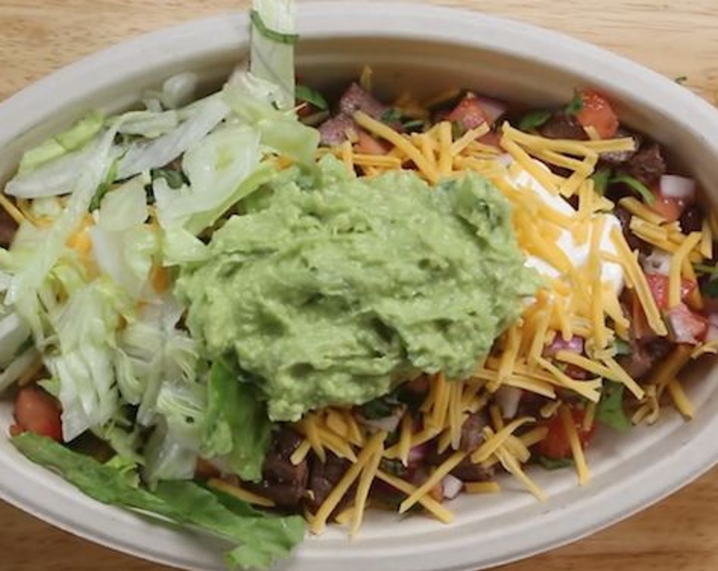 step 6 To assemble the steak bowl add 1/2 cup of the cilantro rice, Canned Black Beans (1/2 cup), Beef Steak Chunks, Salsa, Sour Cream (1 Tbsp), Cheddar Cheese (1/4 cup), 1/2 cup of the guacamole and finish with Shredded Iceberg Lettuce (1/2 cup). Serve and enjoy!