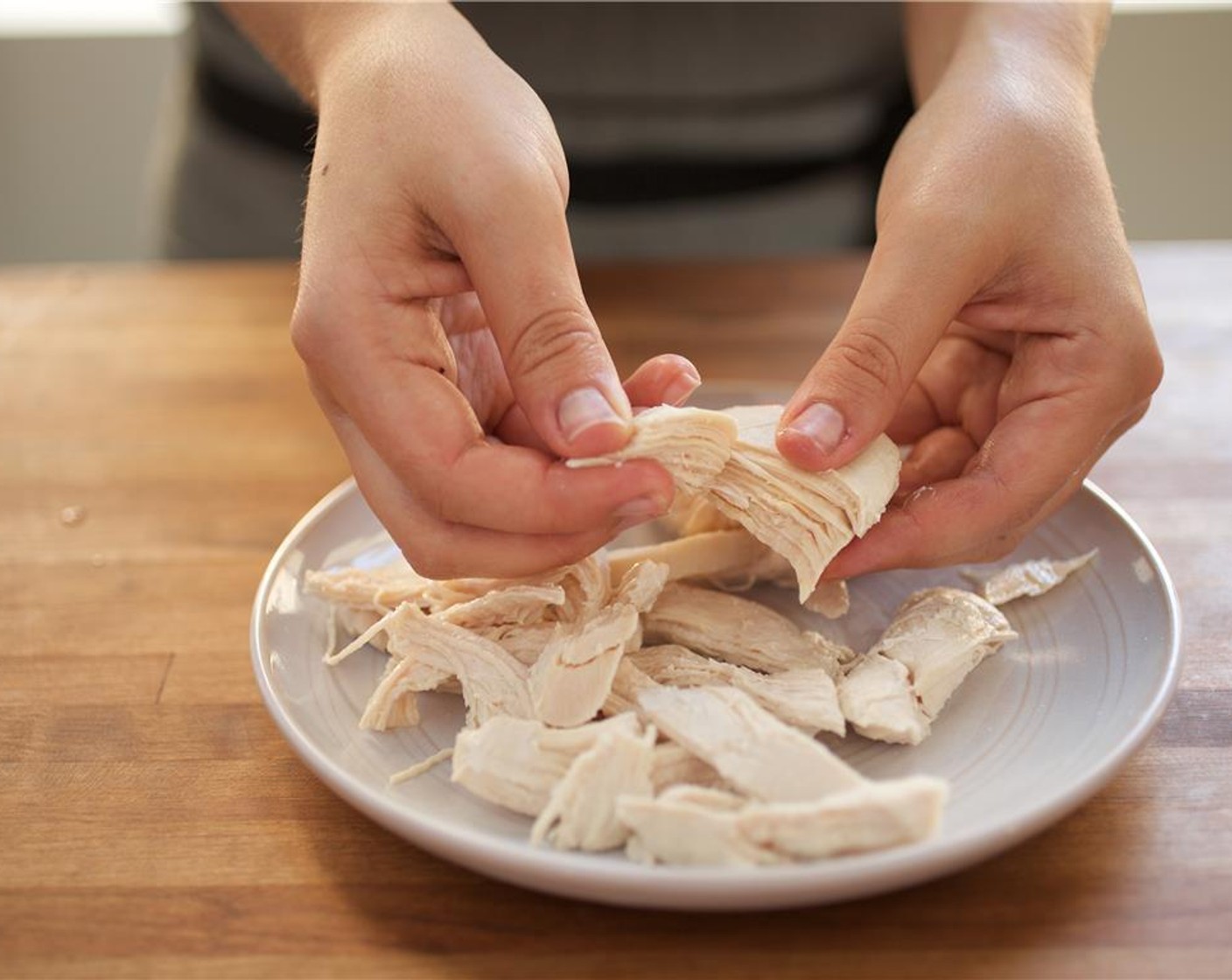 step 8 Remove chicken, cool, and shred meat. Keep water on high heat for the next step. Set shredded chicken aside for plating.