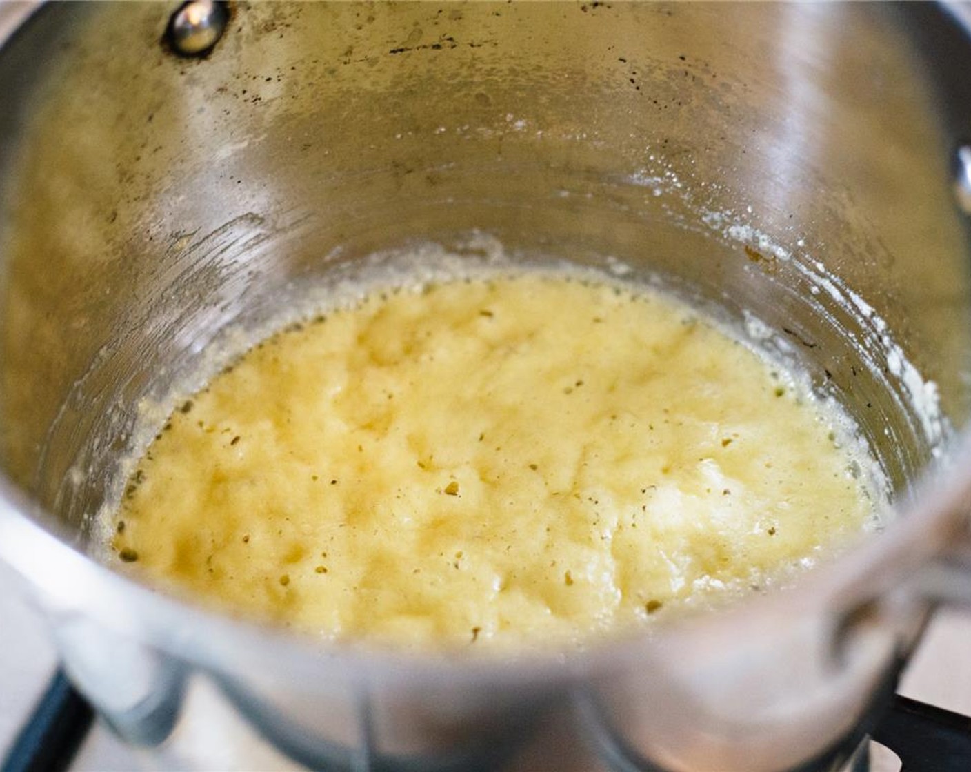 step 3 Reduce to low heat and continue to whisk as the mixture cooks into a paste (roux), about two minutes. Be careful not to let it burn.