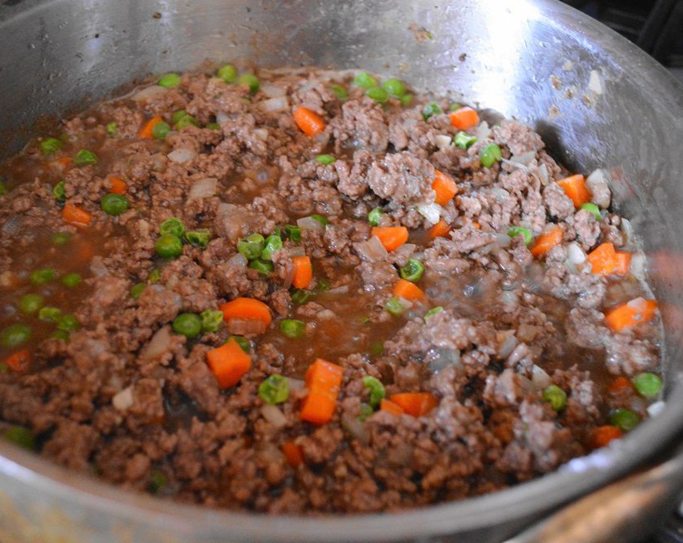 step 3 Heat the Canola Oil (1 dash) in a large skillet over medium high heat. Brown the Ground Beef (1.5 lb) in it while you break it up with a spoon, which should take about 4-5 minutes. Drain off any excess grease.