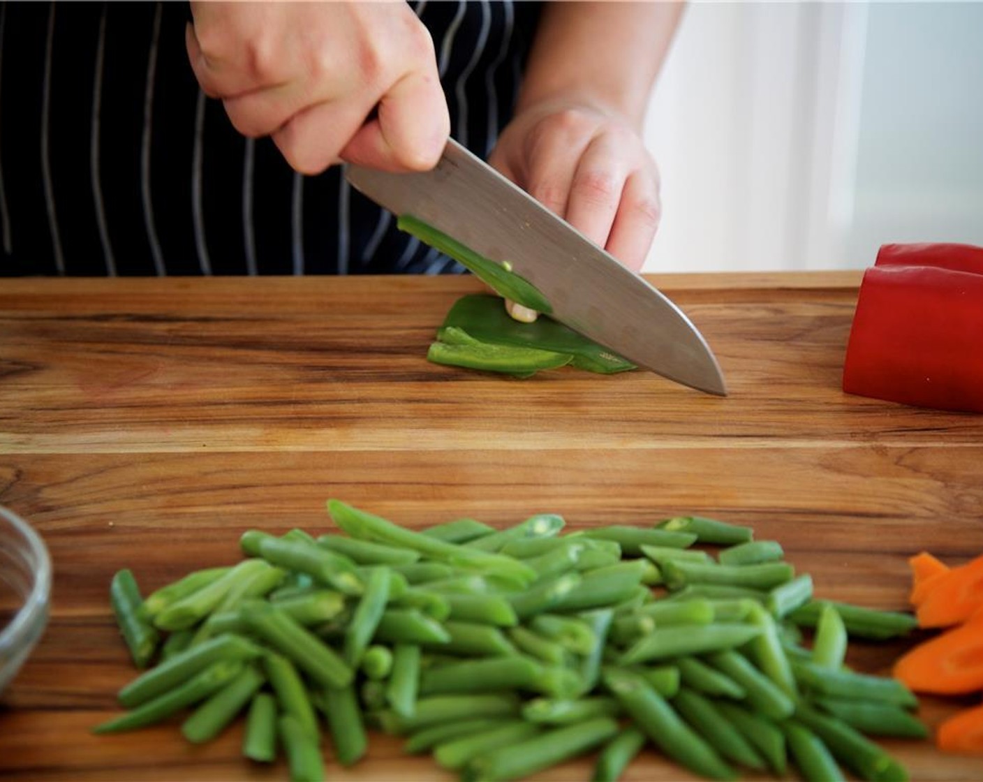 step 10 Cut the remaining pepper halves into thin, long strips. Add to medium bowl with carrots and mushrooms.