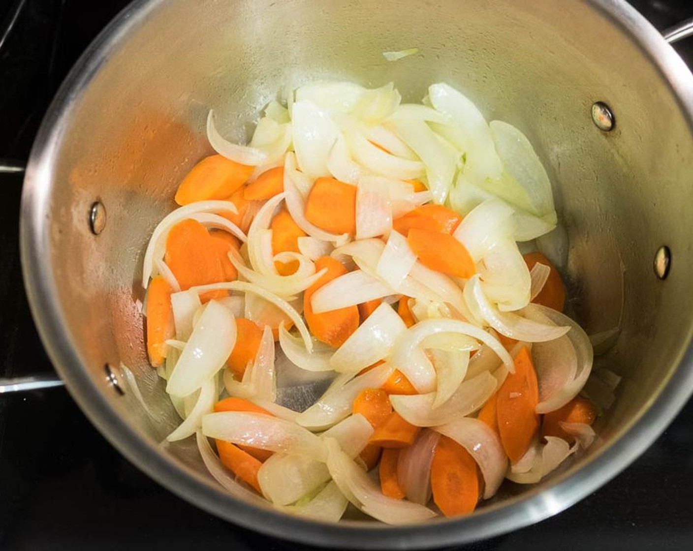 step 6 While waiting the oxtail to cool, heat the big pot - from step 1 - with Olive Oil (2 Tbsp) over medium heat. Add Onion (1) and Carrots (4). Sprinkle with Coarse Sea Salt (1 tsp). Cook and stir until the onion softens, 10 to 15 minutes.