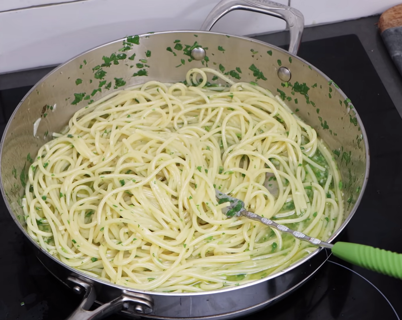 step 8 Increase the temperature on your stove to high heat and continue to stir for one more minute allowing the spaghetti aglio olio to really dance together in the pan.