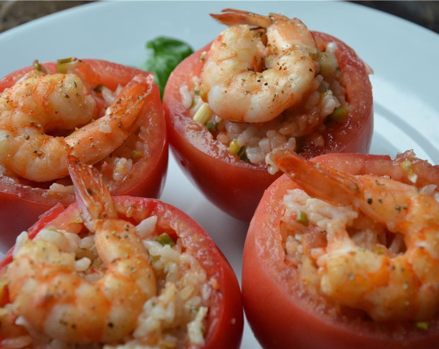 step 6 Put the some of the rice mixture and a shrimp into the tomatoese shells. Top each with a cooked shrimp.